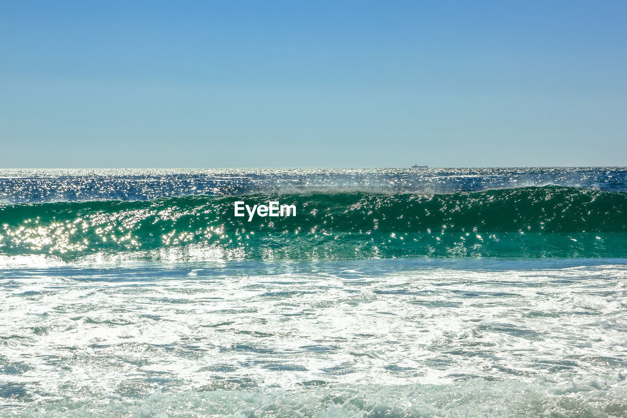 Scenic view of sea against clear blue sky