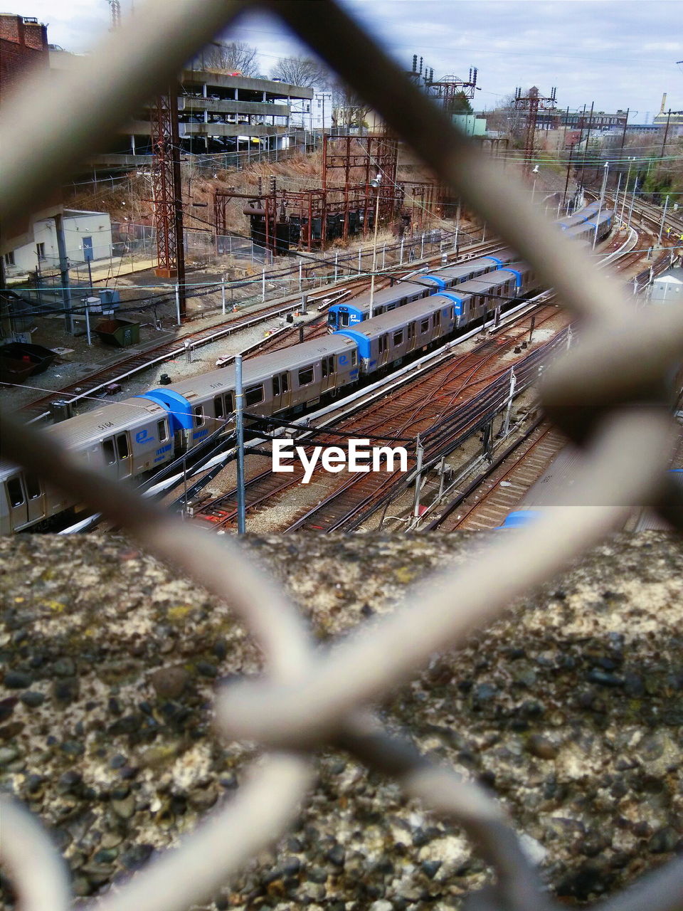 CLOSE-UP OF CHAINLINK FENCE AGAINST SKY