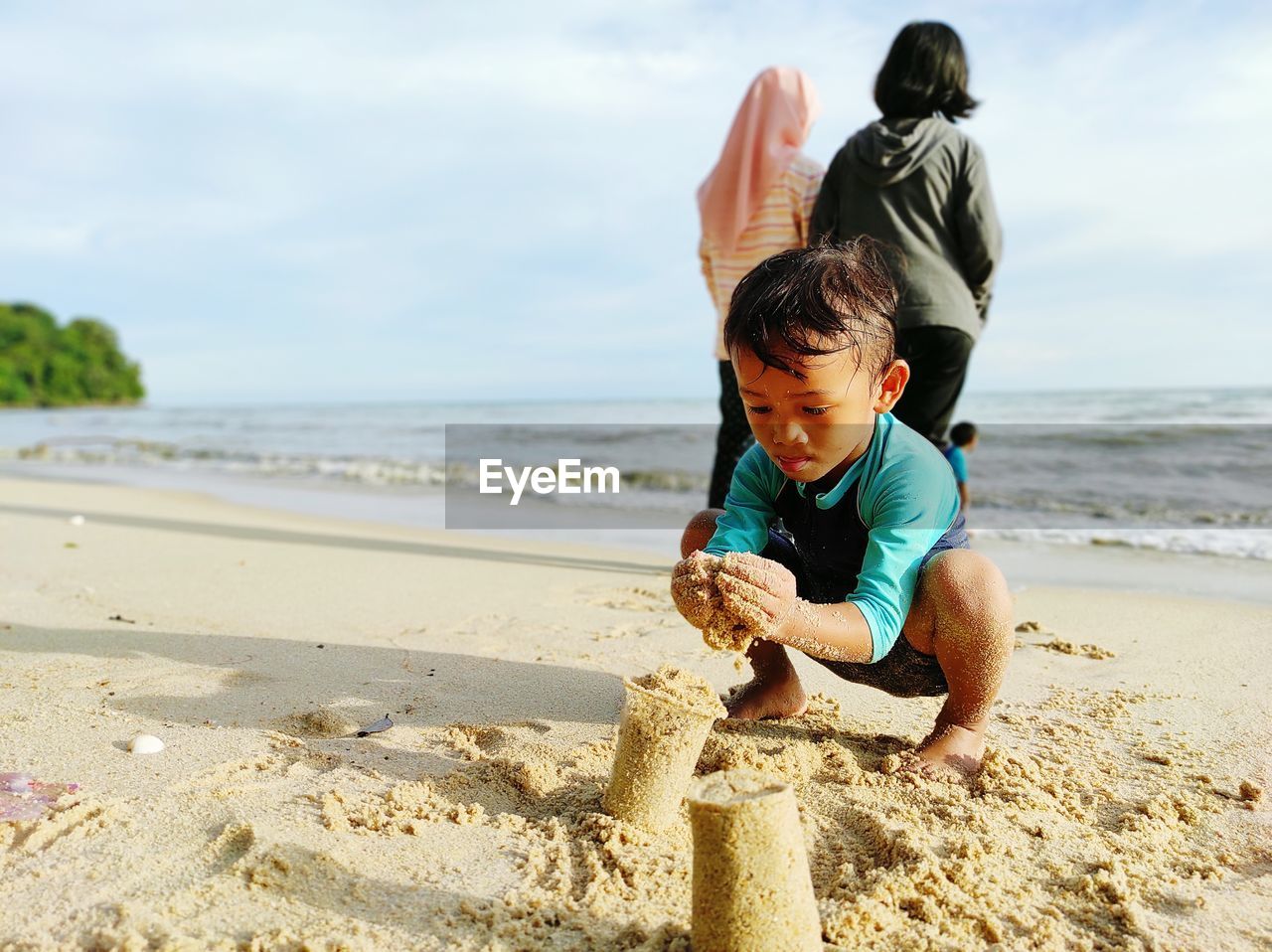 June 2020, asian boy playing sand beach alone at pantai teluk bayu, pulau pinang, malaysia