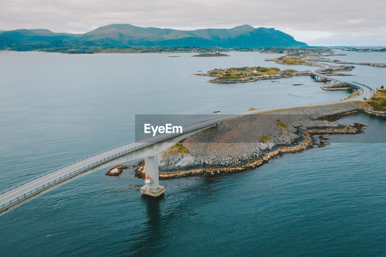 Aerial view of bridge by sea against sky