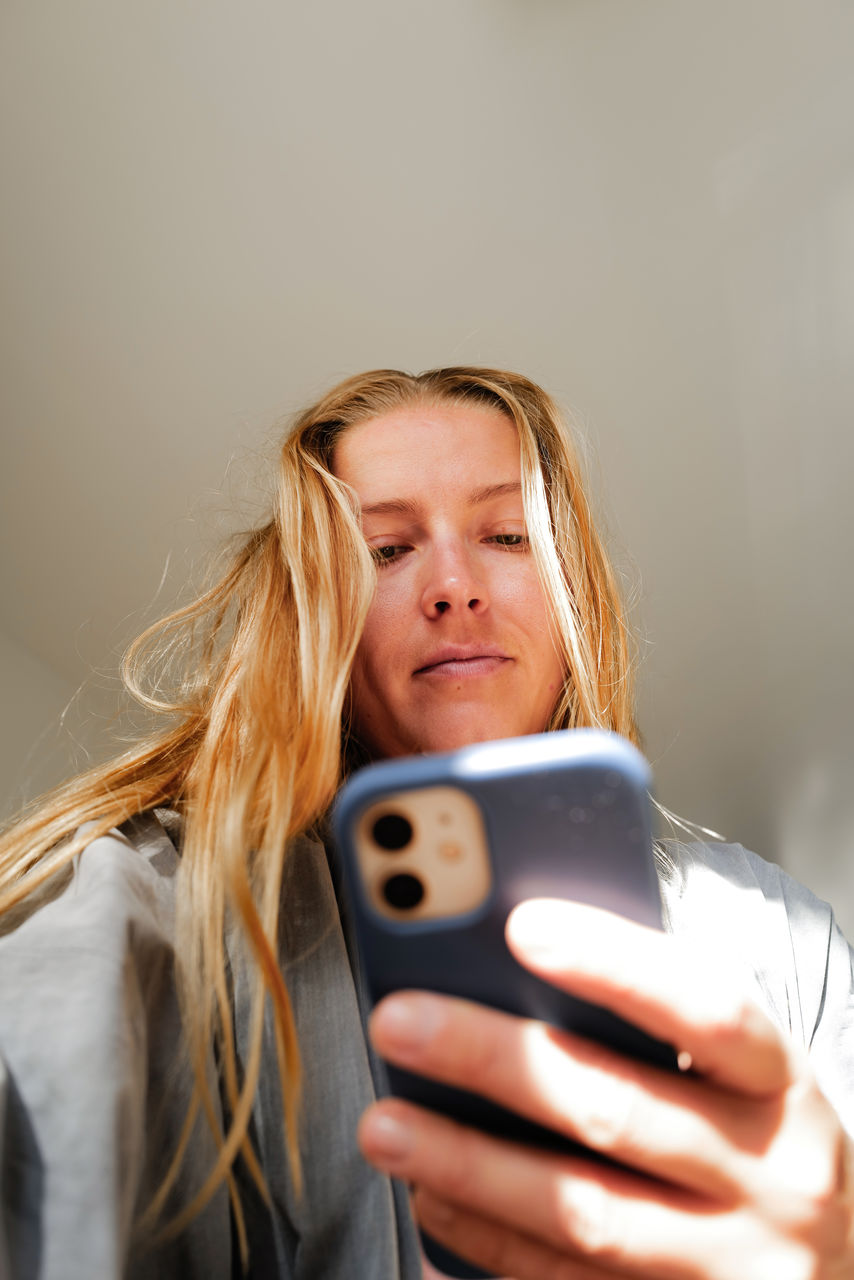 Low angle view on woman using her mobile phone