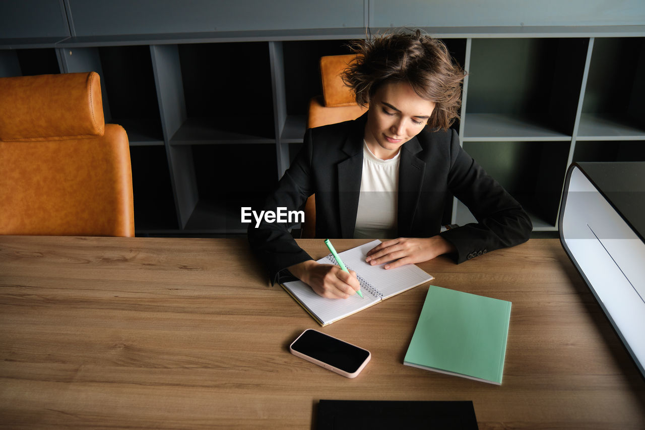 side view of business colleagues working on table