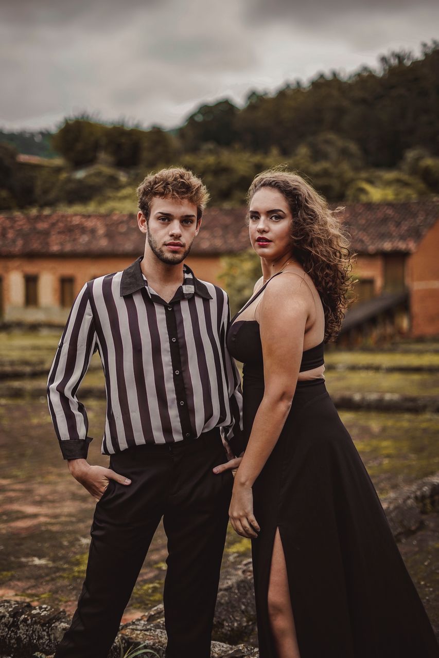 PORTRAIT OF COUPLE STANDING OUTDOORS