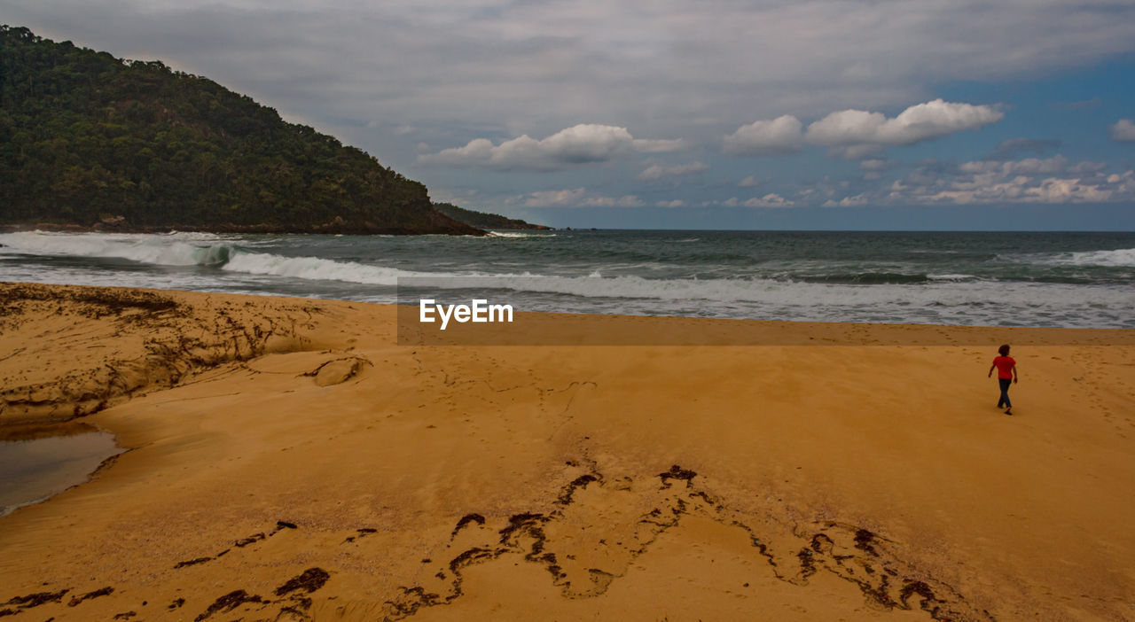 SCENIC VIEW OF BEACH AGAINST SKY DURING SUNRISE