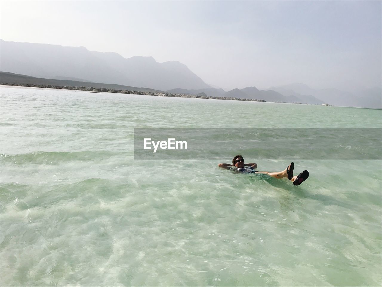 High angle view of person swimming in lake against clear sky