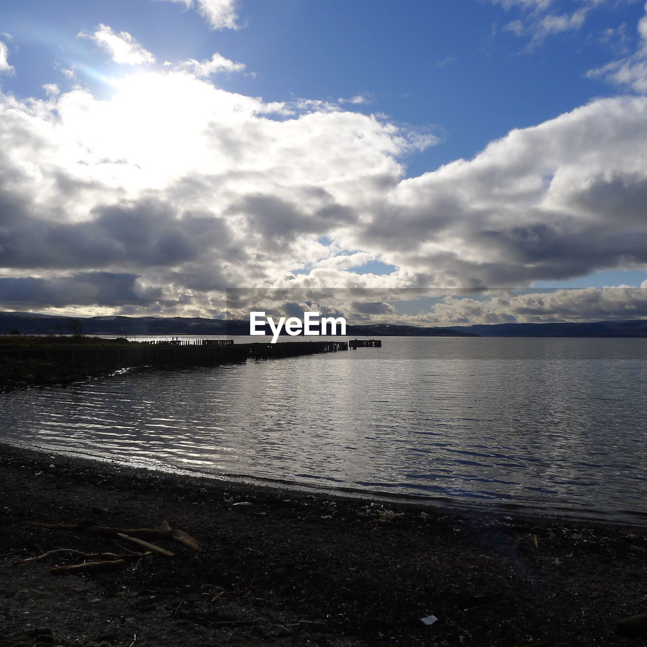 Scenic view of sea against cloudy sky