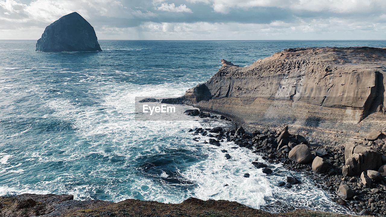 sea, water, rock, ocean, land, beach, cliff, coast, wave, sky, beauty in nature, scenics - nature, nature, shore, cloud, terrain, wind wave, travel destinations, environment, horizon over water, body of water, travel, landscape, horizon, coastline, motion, rock formation, outdoors, no people, seascape, tranquility, bay, rocky coastline, tranquil scene, tourism, day, holiday, non-urban scene, sports, water sports, trip, blue, animal wildlife, idyllic, animal, vacation