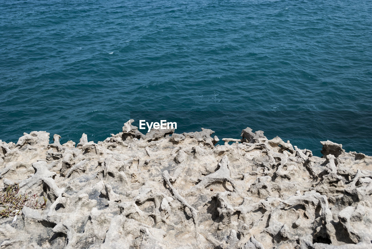 Scenic view of sea against rocks