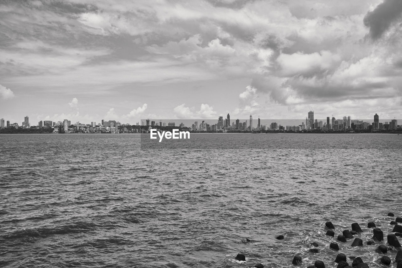 SEA AND BUILDINGS AGAINST SKY