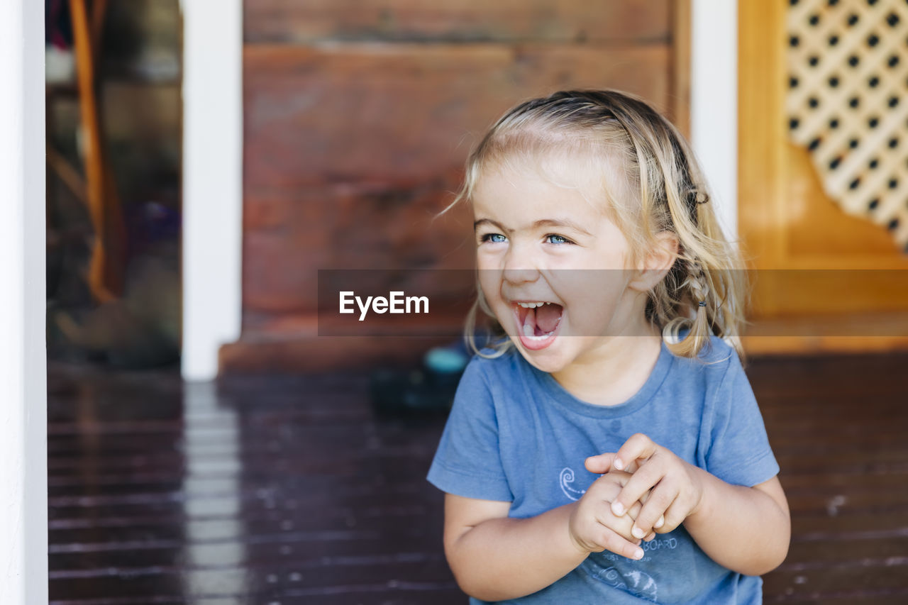 Close-up of cheerful girl looking away