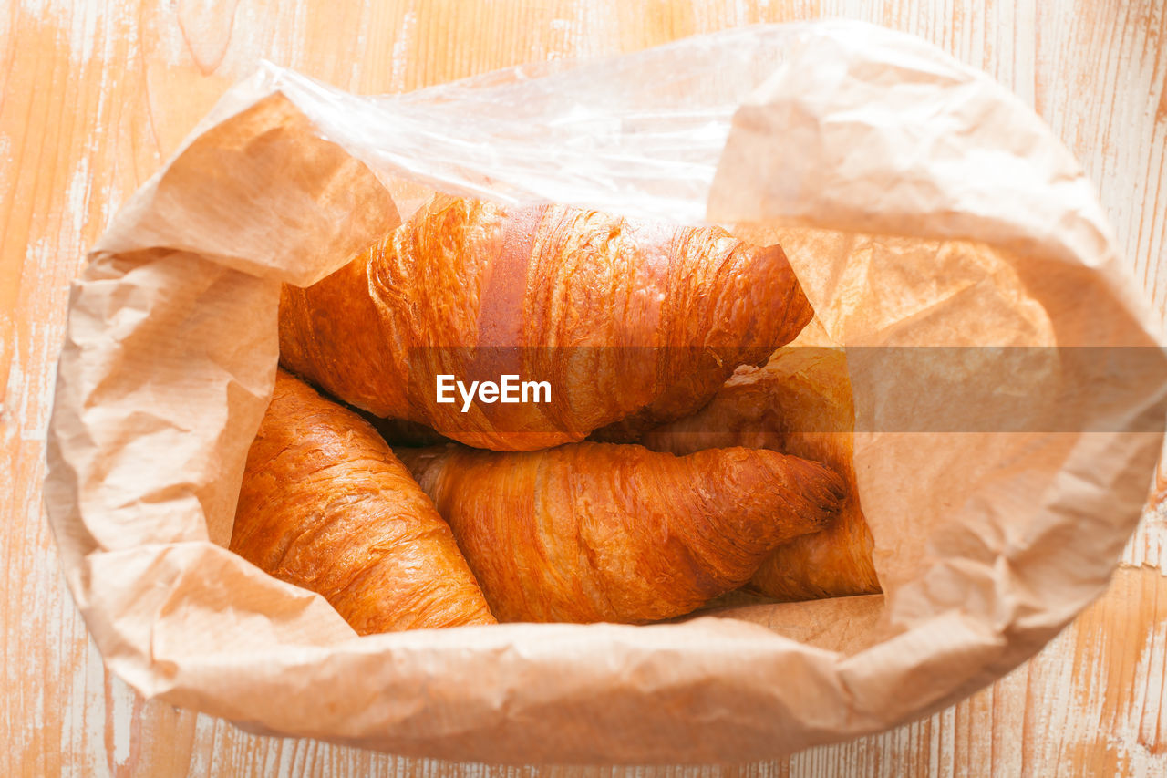 Croissants packed in brown paper bag