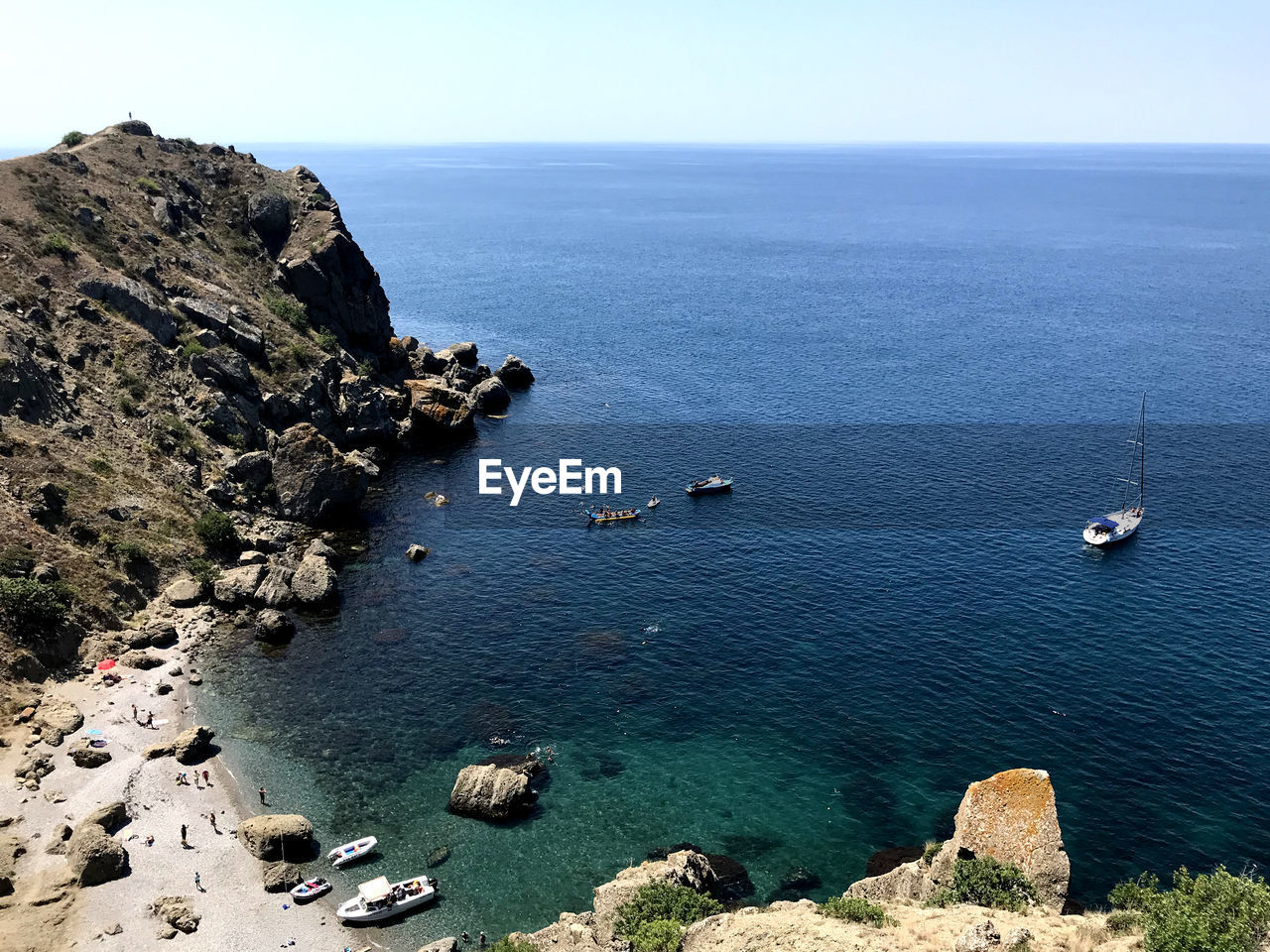 High angle view of sailboats on sea shore against sky