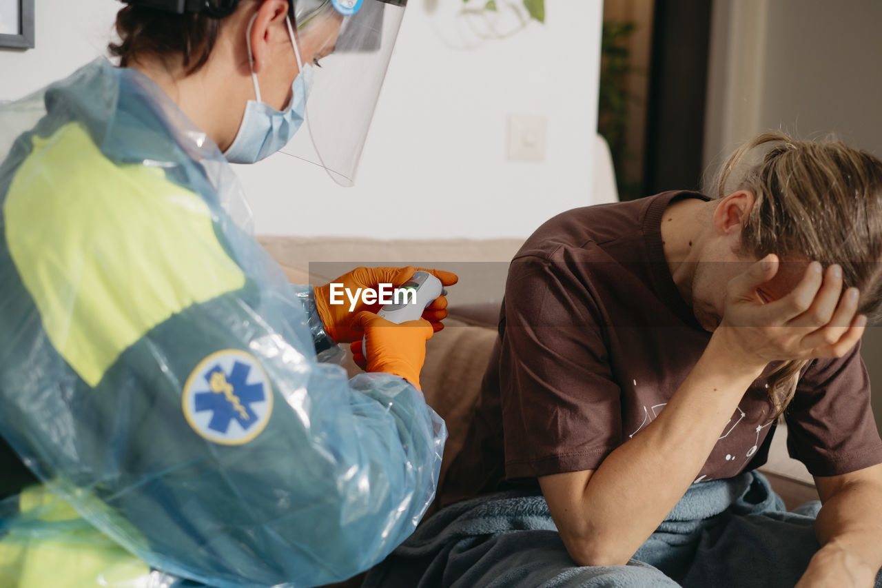 Doctor examining patient at home