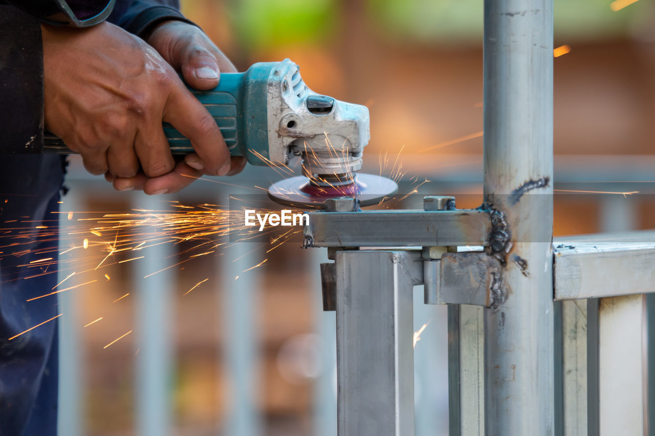 Midsection of man working in factory