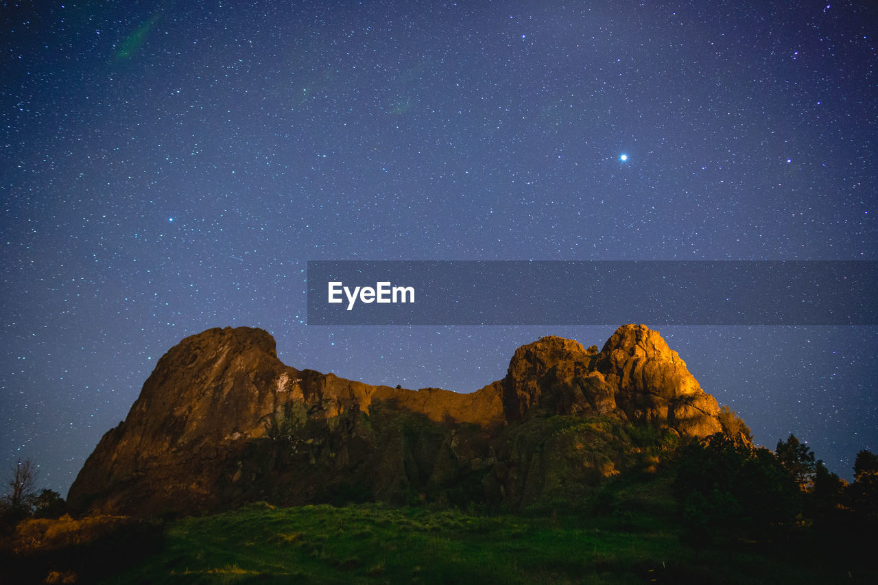 Scenic view of mountain against sky at night