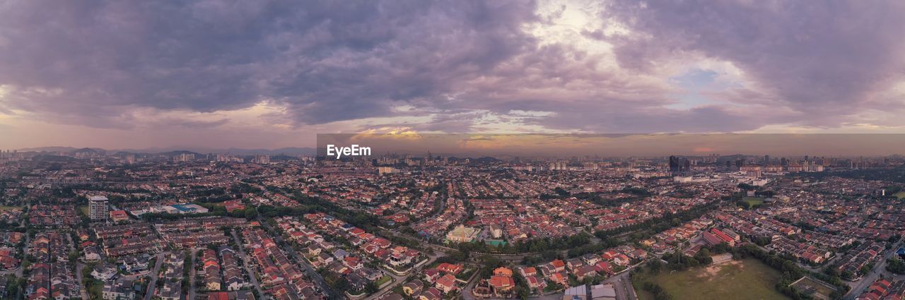 HIGH ANGLE SHOT OF TOWNSCAPE AGAINST SKY DURING SUNSET