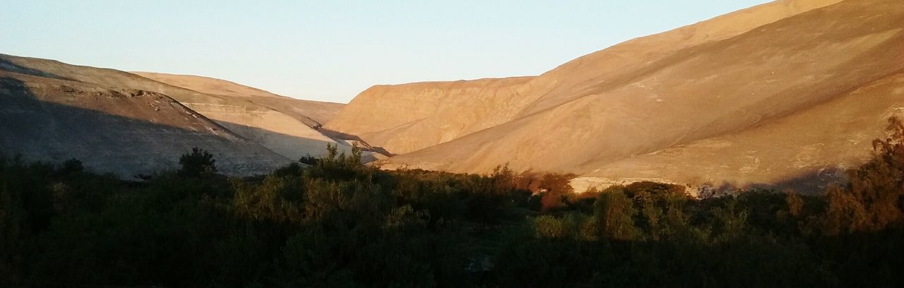 PANORAMIC SHOT OF MOUNTAINS AGAINST CLEAR SKY