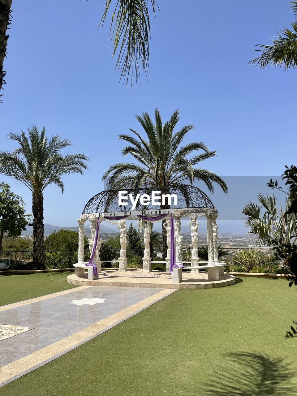 palm tree, tropical climate, tree, plant, nature, sky, architecture, day, coconut palm tree, no people, outdoors, built structure, palm leaf, water, travel destinations, vacation, clear sky, tropical tree, sunny, date palm tree, travel, growth, low angle view, sunlight, holiday, land, beach, beauty in nature