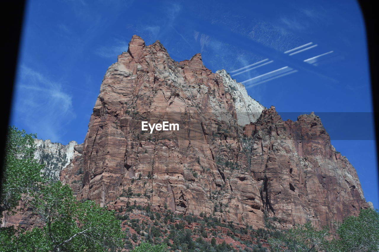 Low angle view of rock formation against blue sky