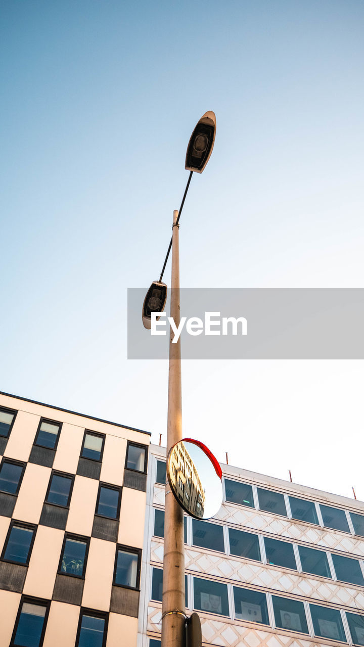 Low angle view of street light against building