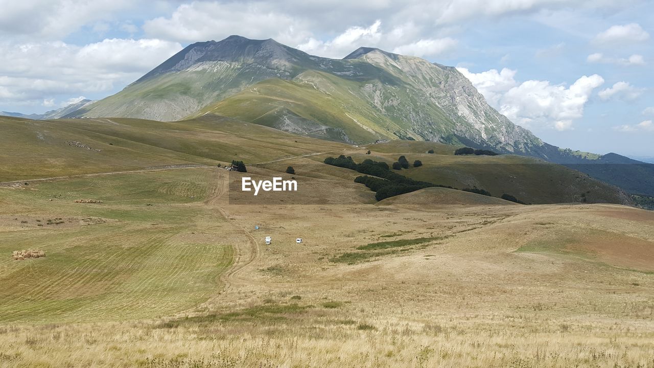 Scenic view of mountains against cloudy sky