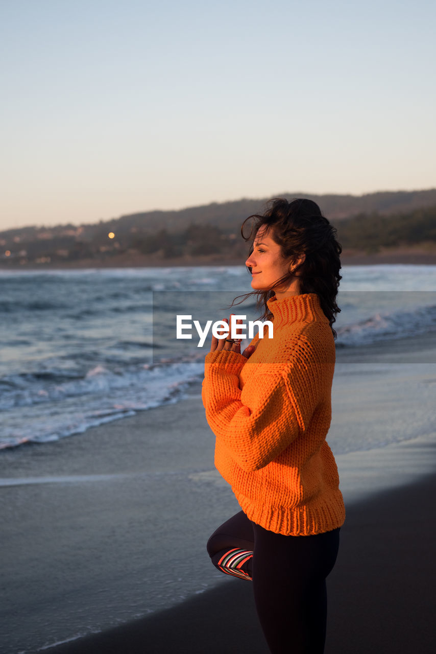 Peaceful woman takes in the view at sunset