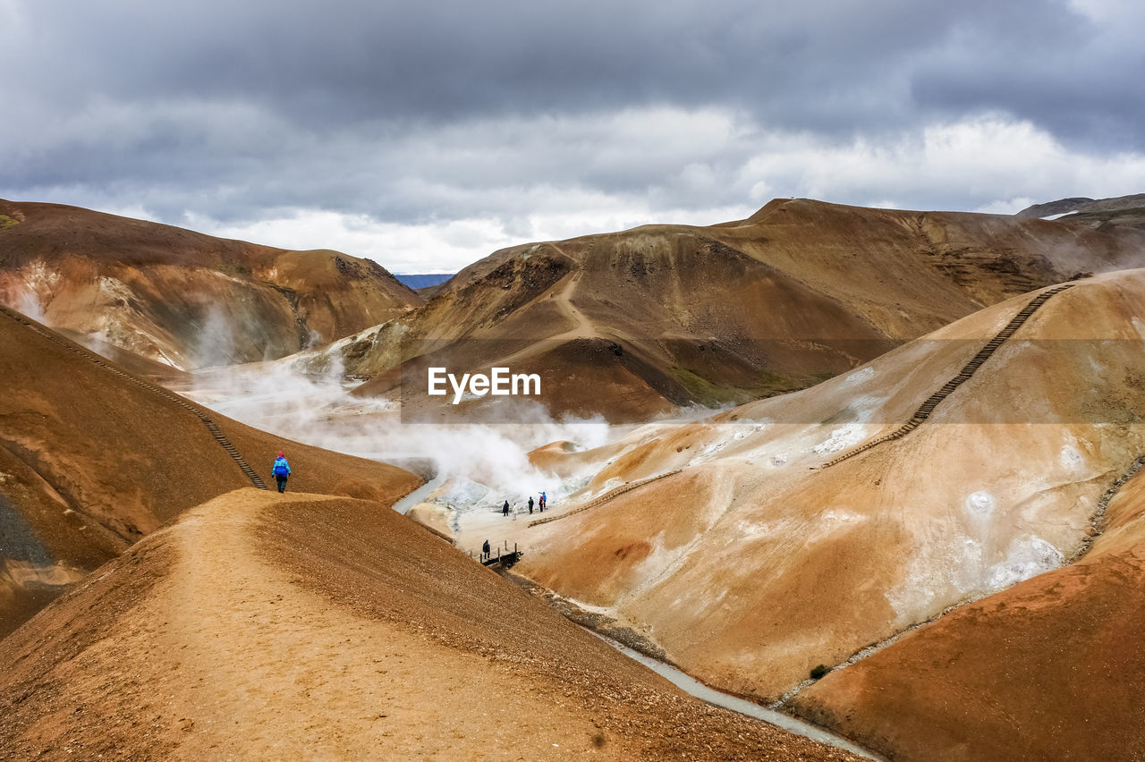 Scenic view of mountains against cloudy sky