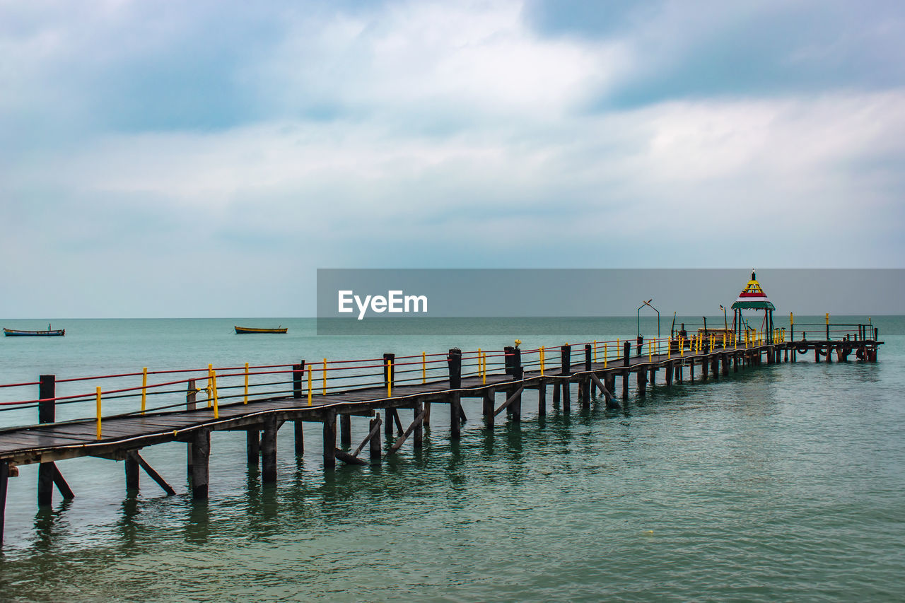 Pier over sea against sky