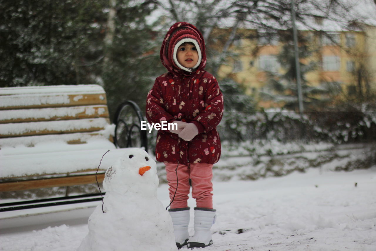 Portrait of woman standing in snow