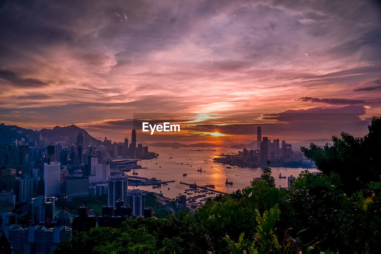 Scenic view of buildings against sky during sunset