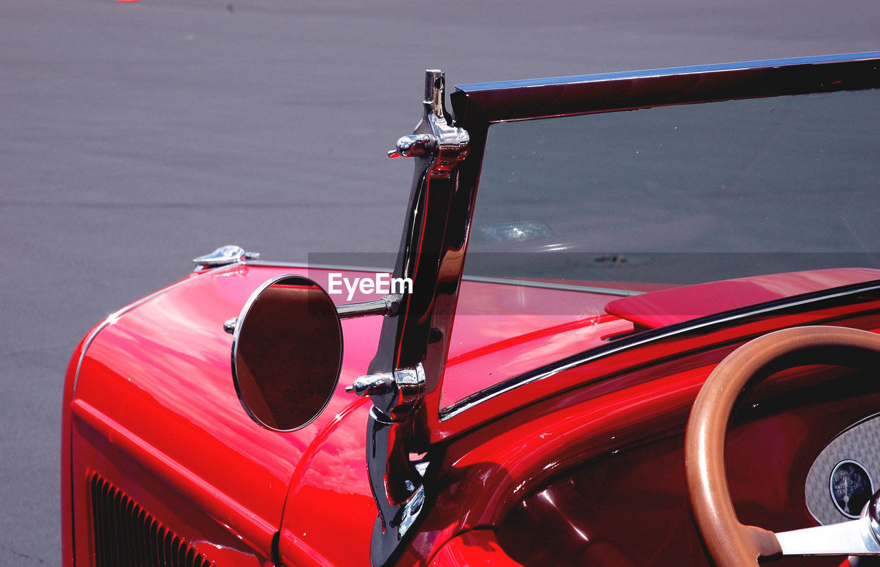 Close-up of red vintage car parked on road