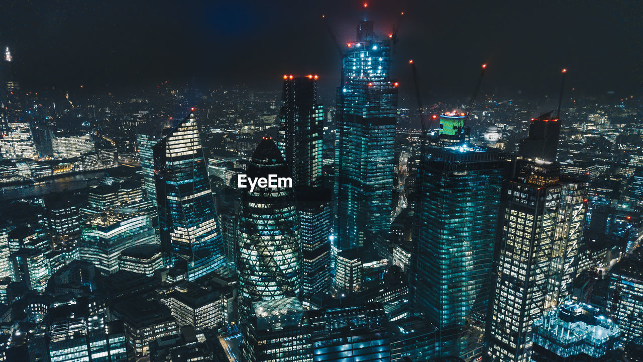 Aerial view of illuminated buildings in city at night