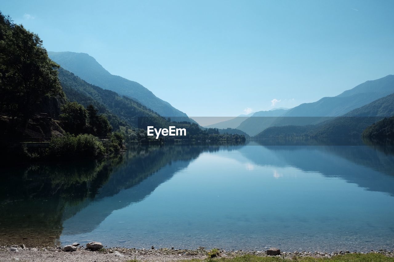 Scenic view of lake and mountains against clear sky