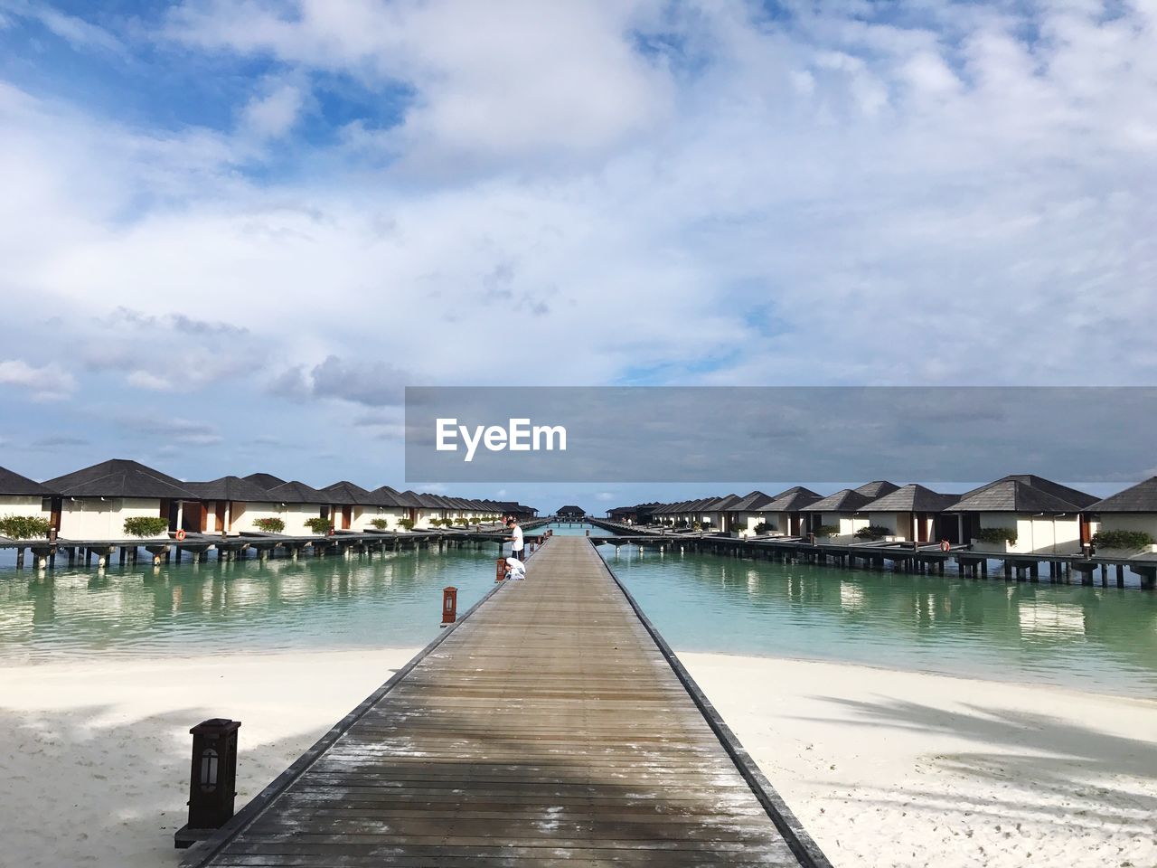 PIER BY SWIMMING POOL AGAINST BUILDINGS