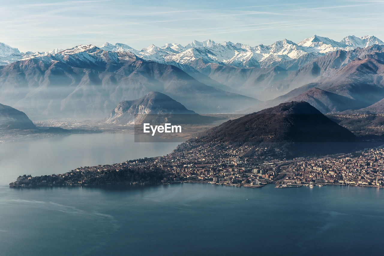 Scenic view of sea and mountains against sky