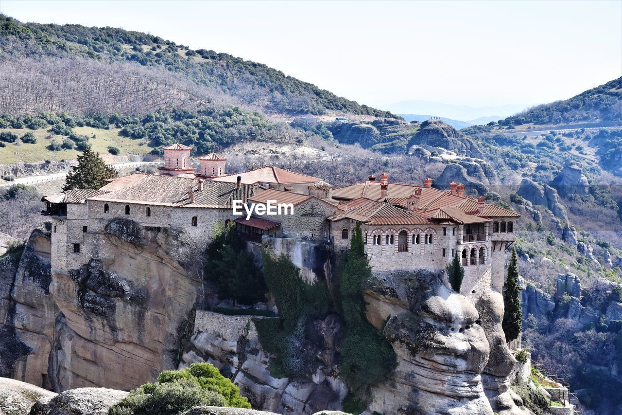 High angle view of buildings and mountains against sky, monastery