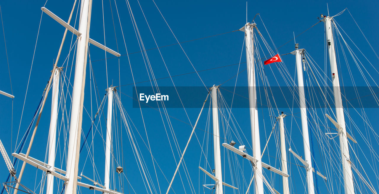 Ship mast in the port of bodrum, turkey in front of cloudless sky