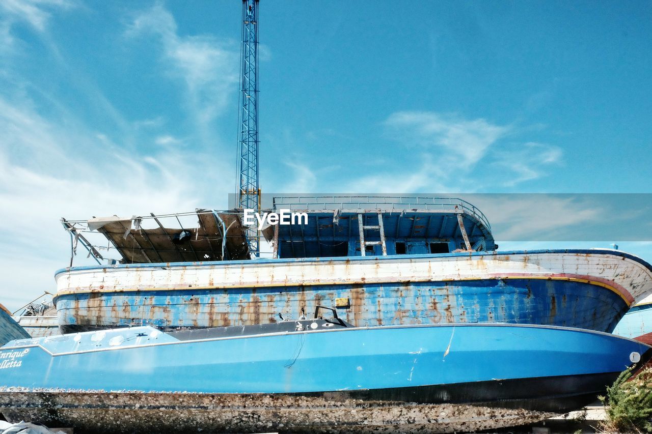 Low angle view of abandoned boat against sky