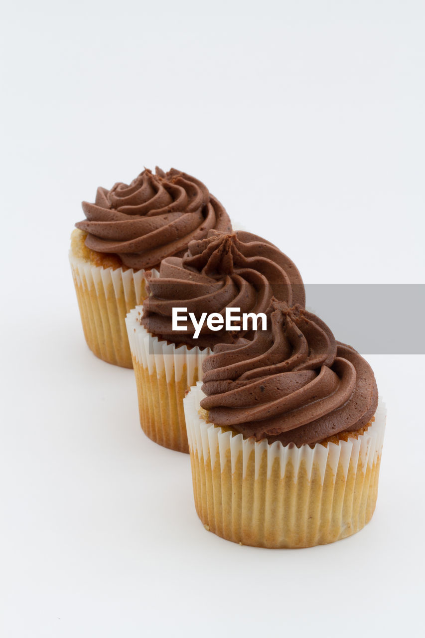 Chocolate cupcakes against white background