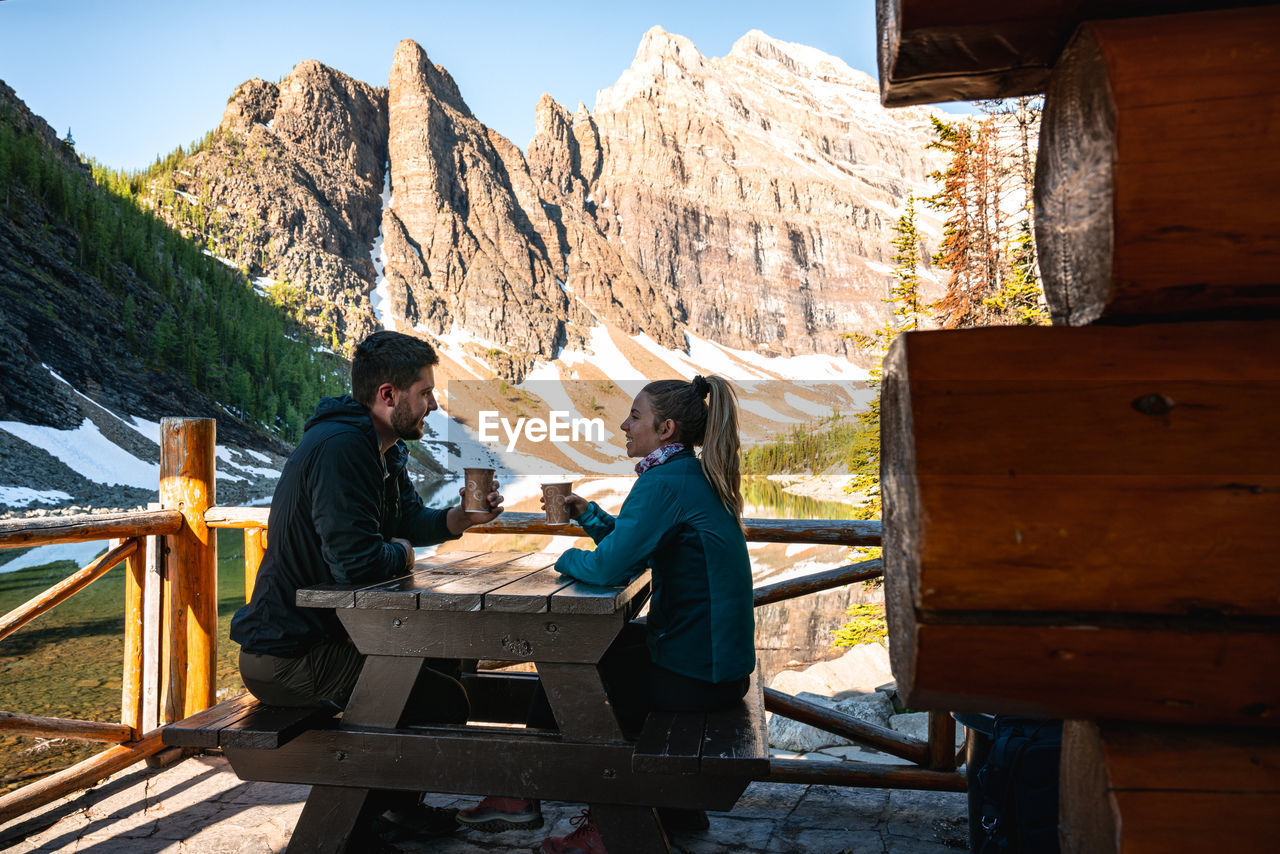 Couple enjoying tea together at lake agnes tea house in lake louise