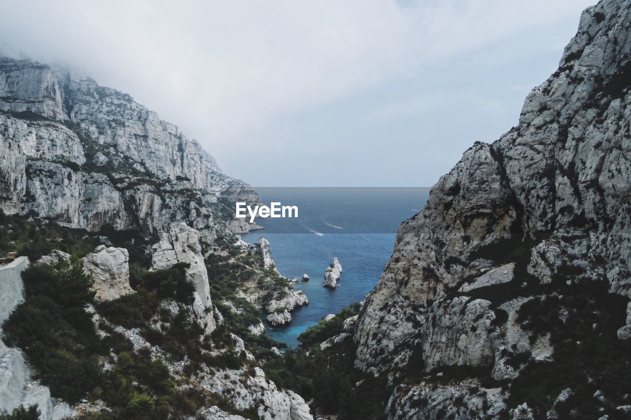 Scenic view of mountains and sea against sky