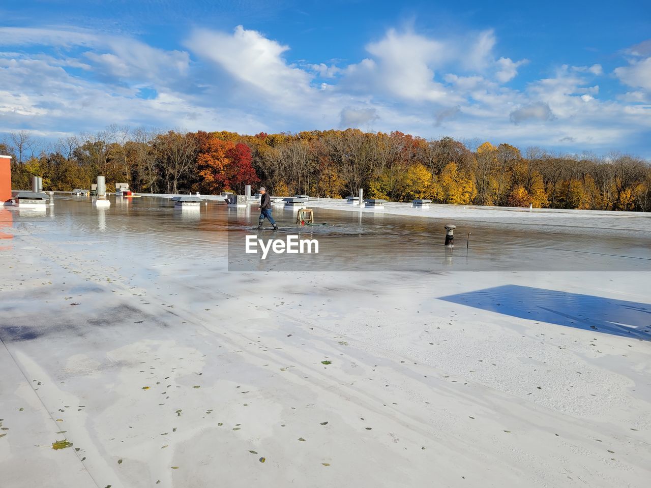 GROUP OF PEOPLE ON LAKE DURING AUTUMN