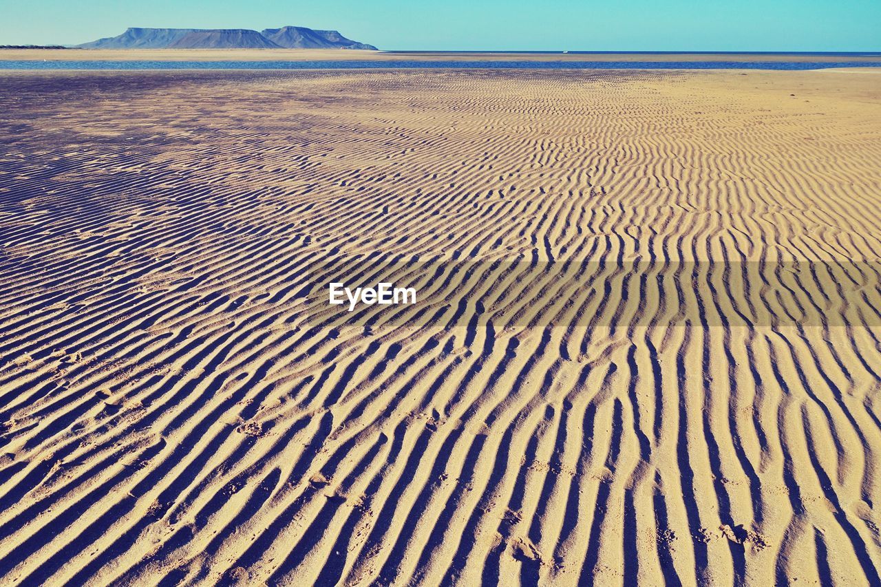 Scenic view of sand against sky