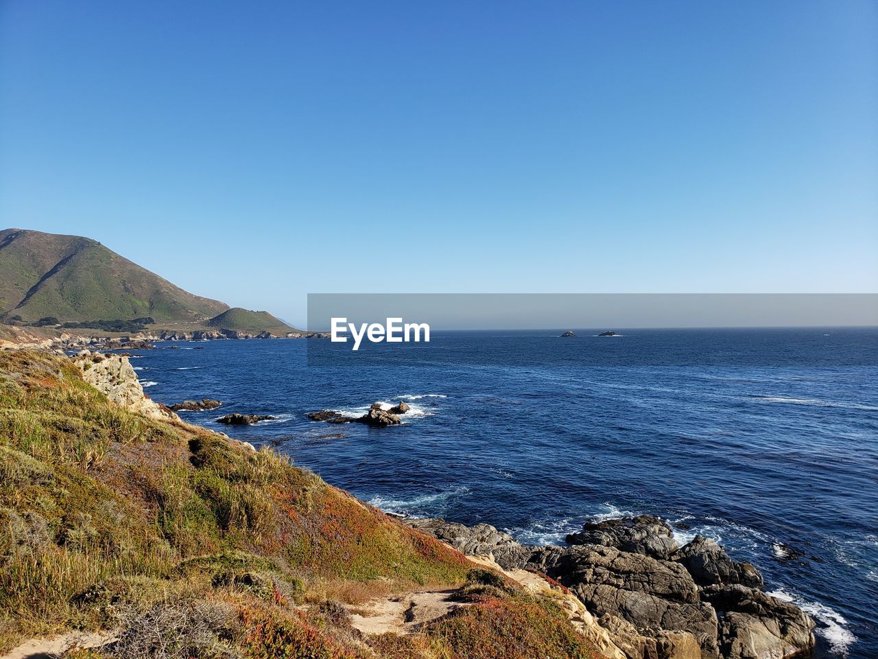 Scenic view of sea against clear blue sky