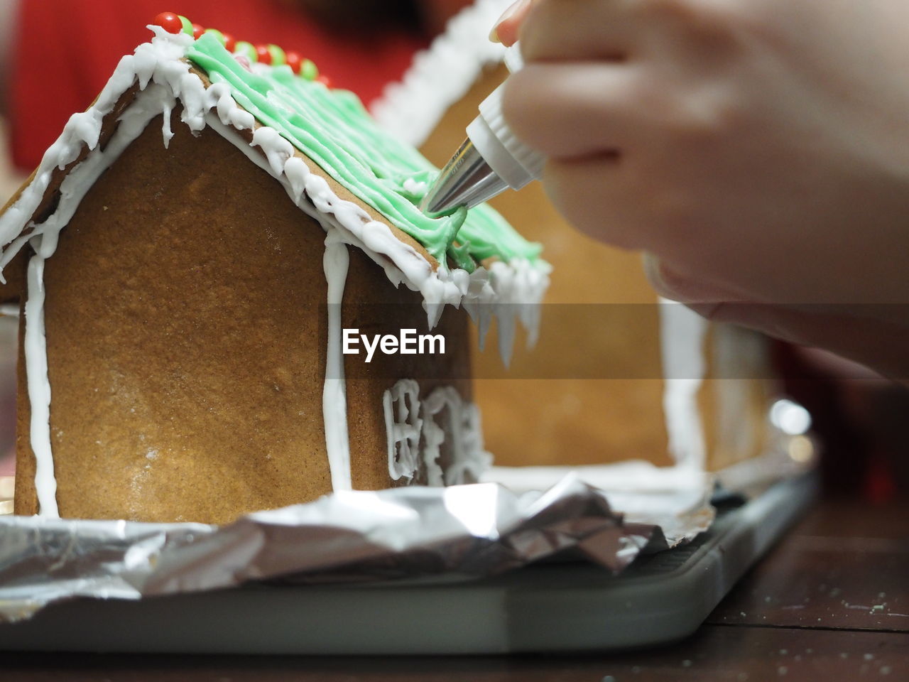 Girls making gingerbread village, happy holidays.