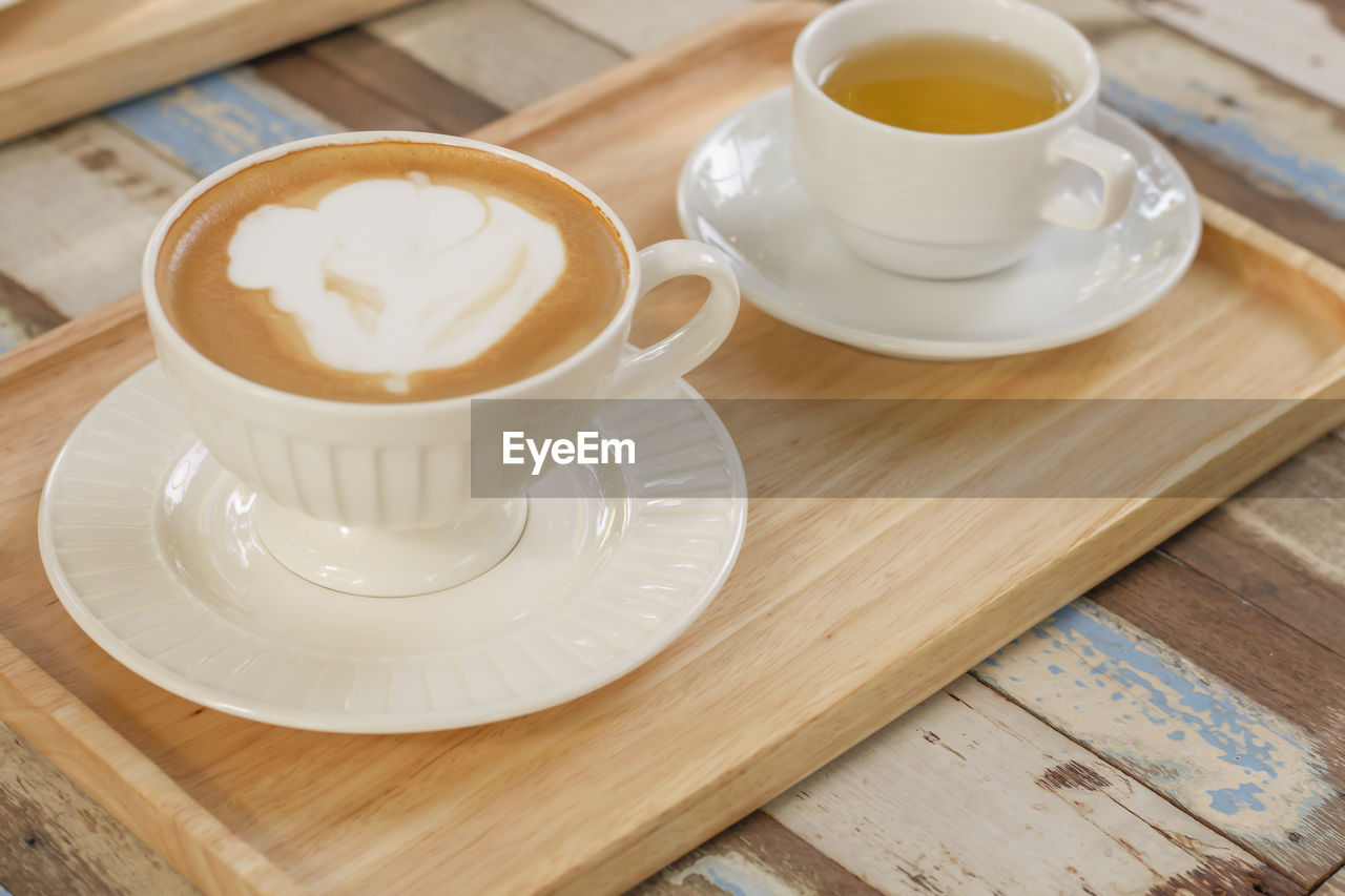 COFFEE CUP AND TEA ON TABLE