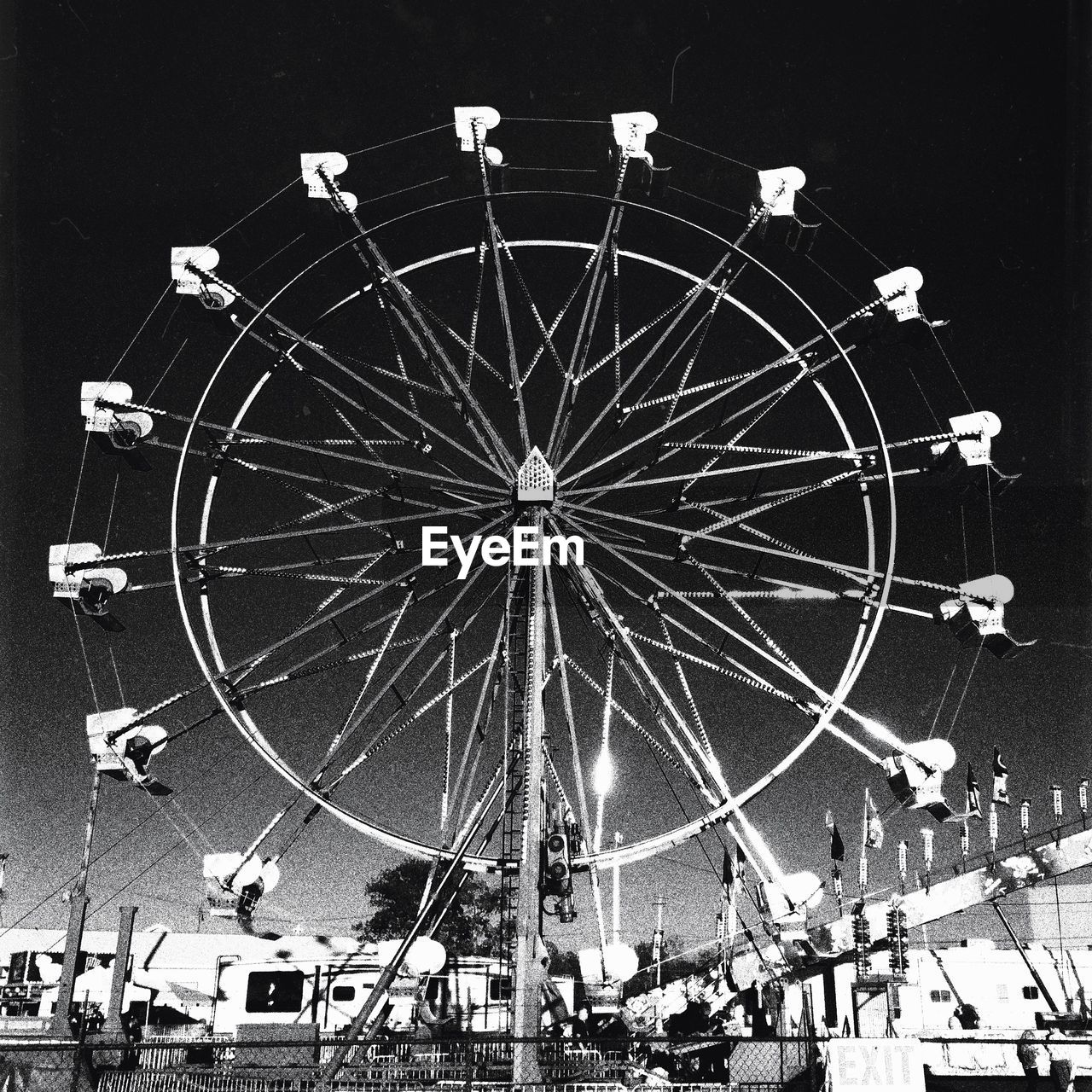 LOW ANGLE VIEW OF FERRIS WHEEL AT NIGHT