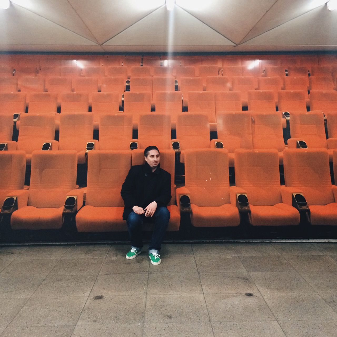 Full length of man sitting in movie theater