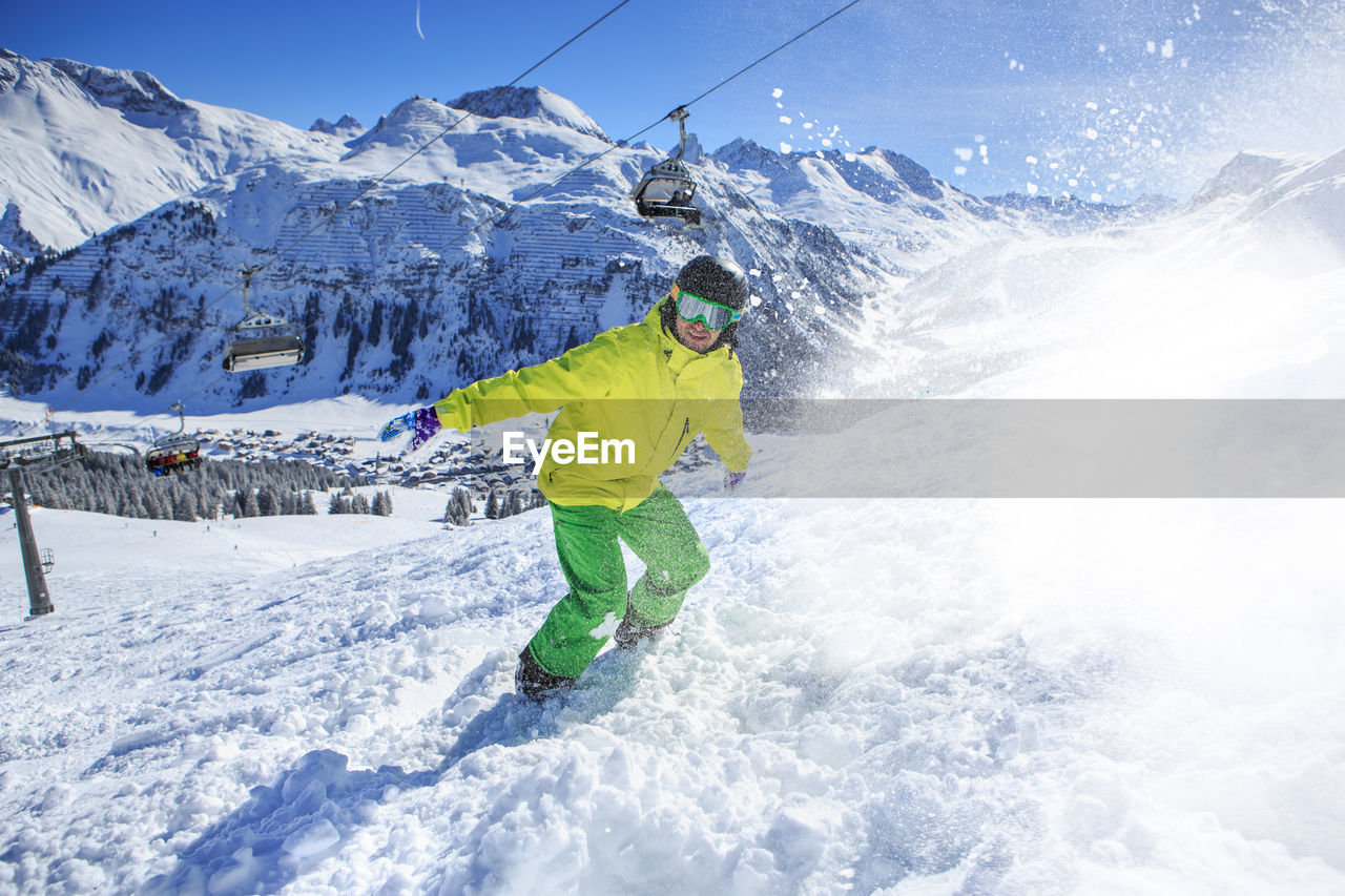 Young man skiing on snowcapped mountains during winter