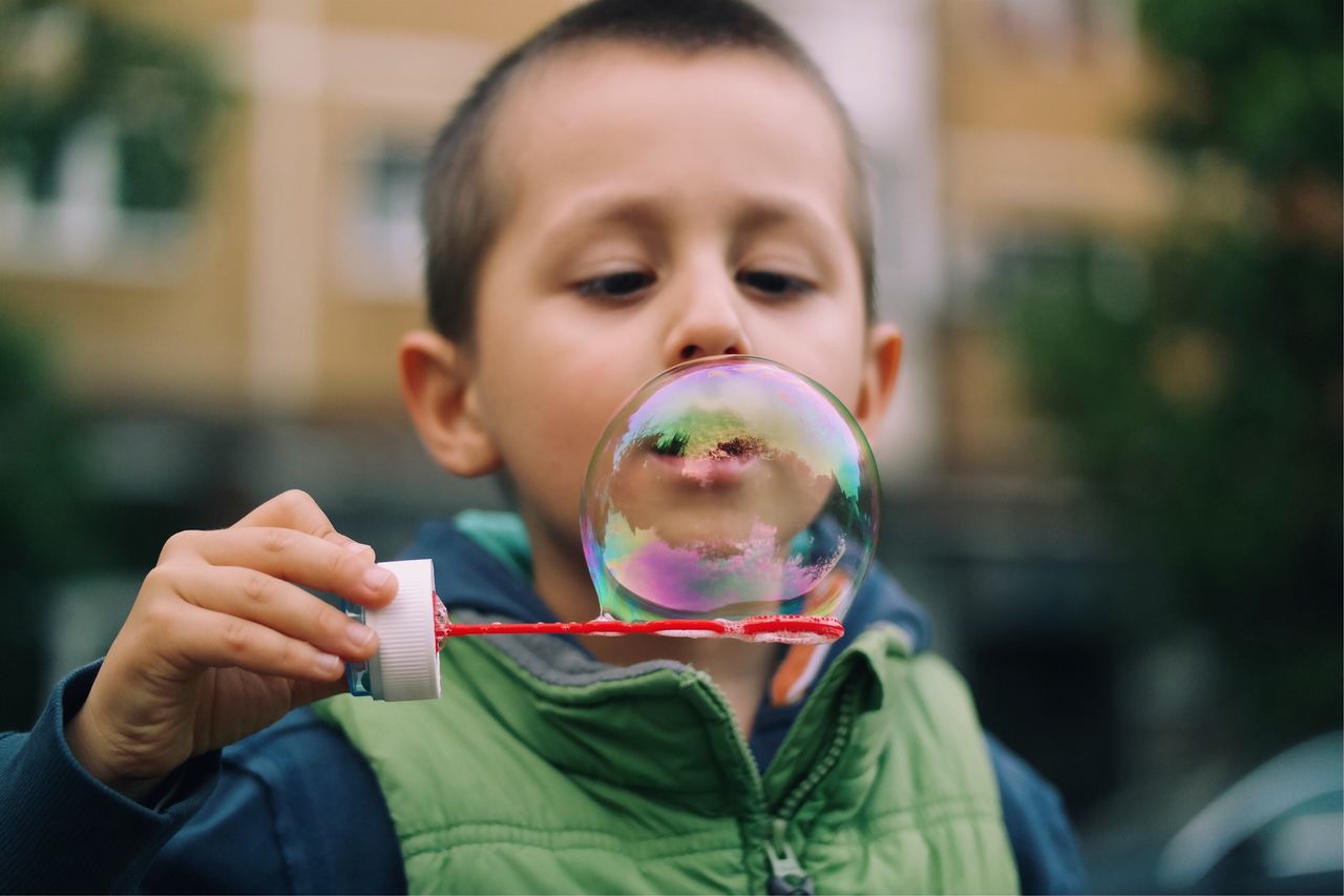 Close-up of boy holding bubble wand